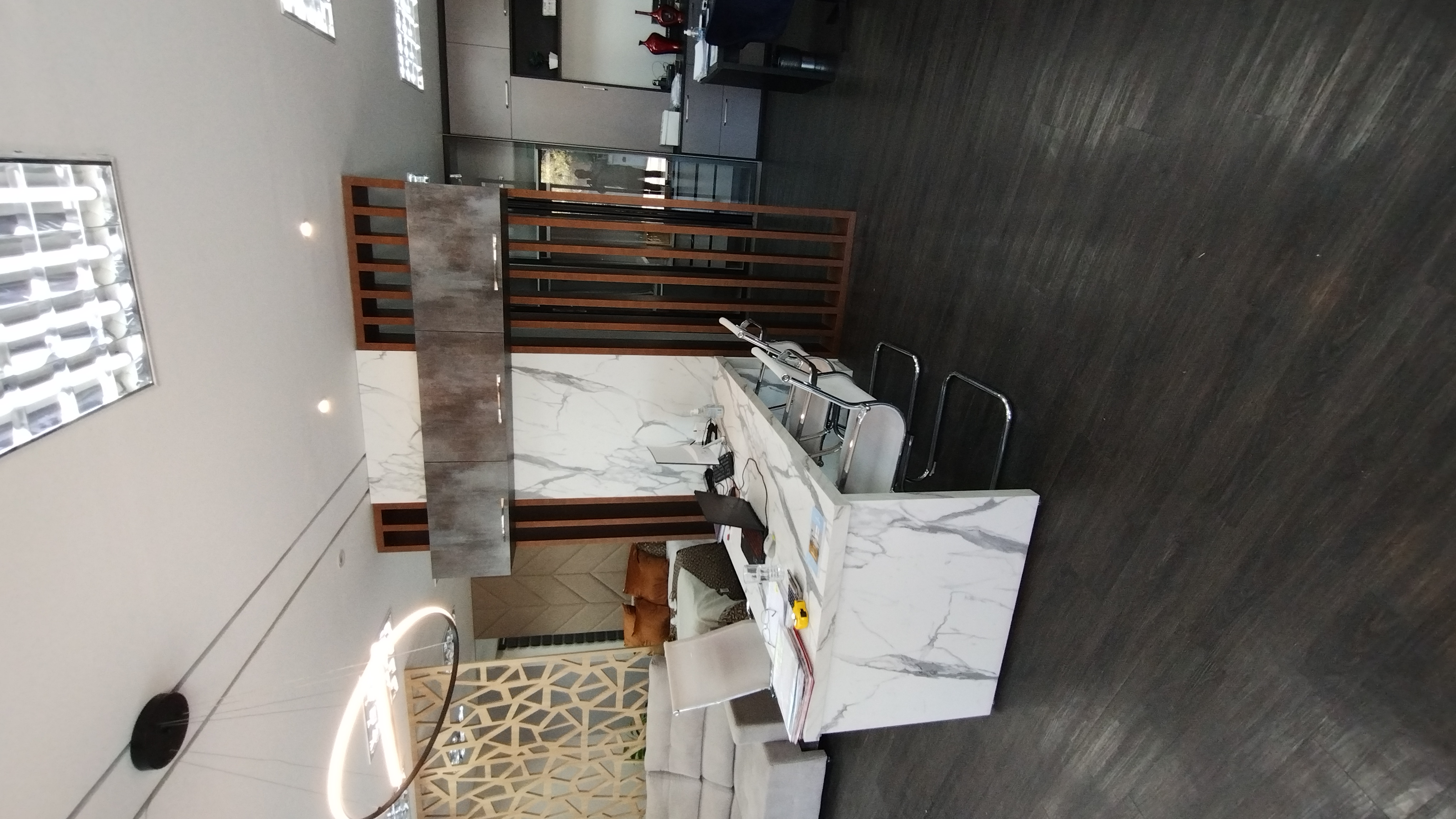 Escritório com móveis planejados e acabamento em mármore